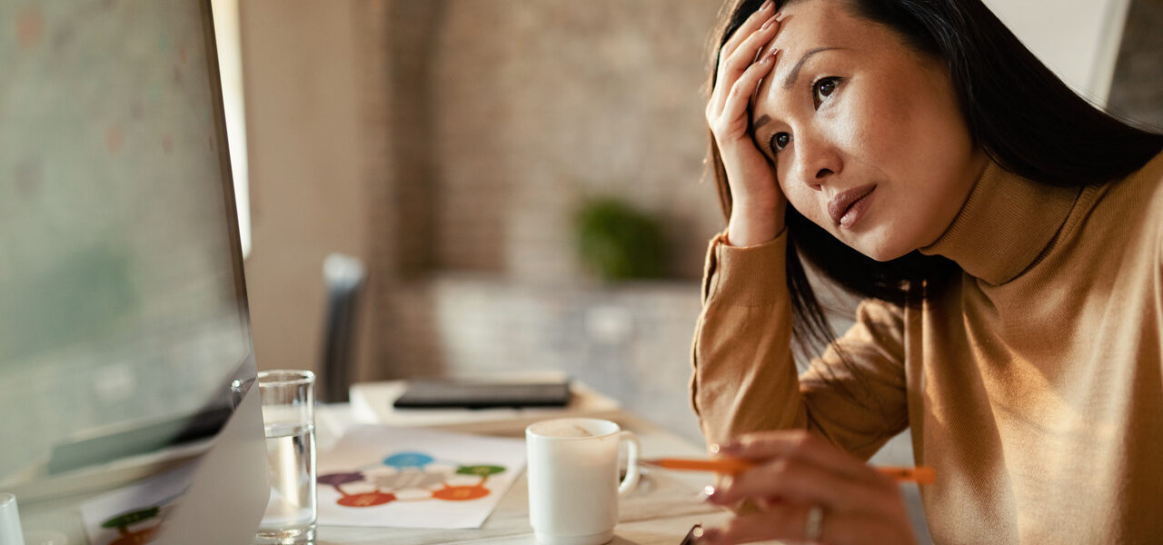 pensive-asian-businesswoman-working-on-a-computer