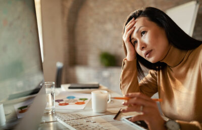pensive-asian-businesswoman-working-on-a-computer
